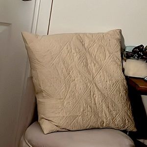 Tan pillow with charming design